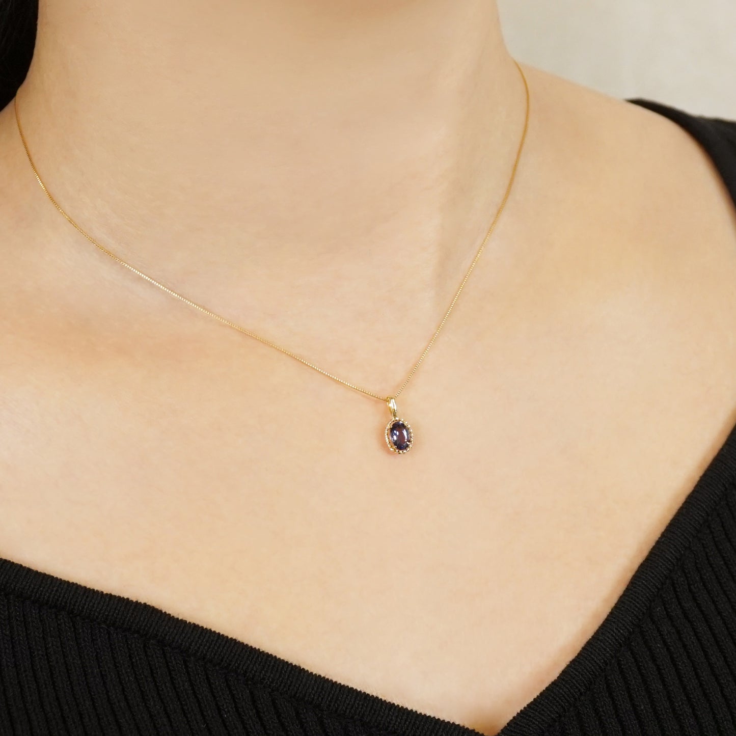 10K Iolite Oval Necklace Charm (Yellow Gold) - Model Image
