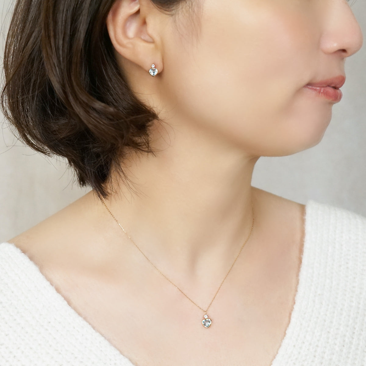 10K Sky Blue Topaz Heart Love Earrings (Yellow Gold) - Model Image