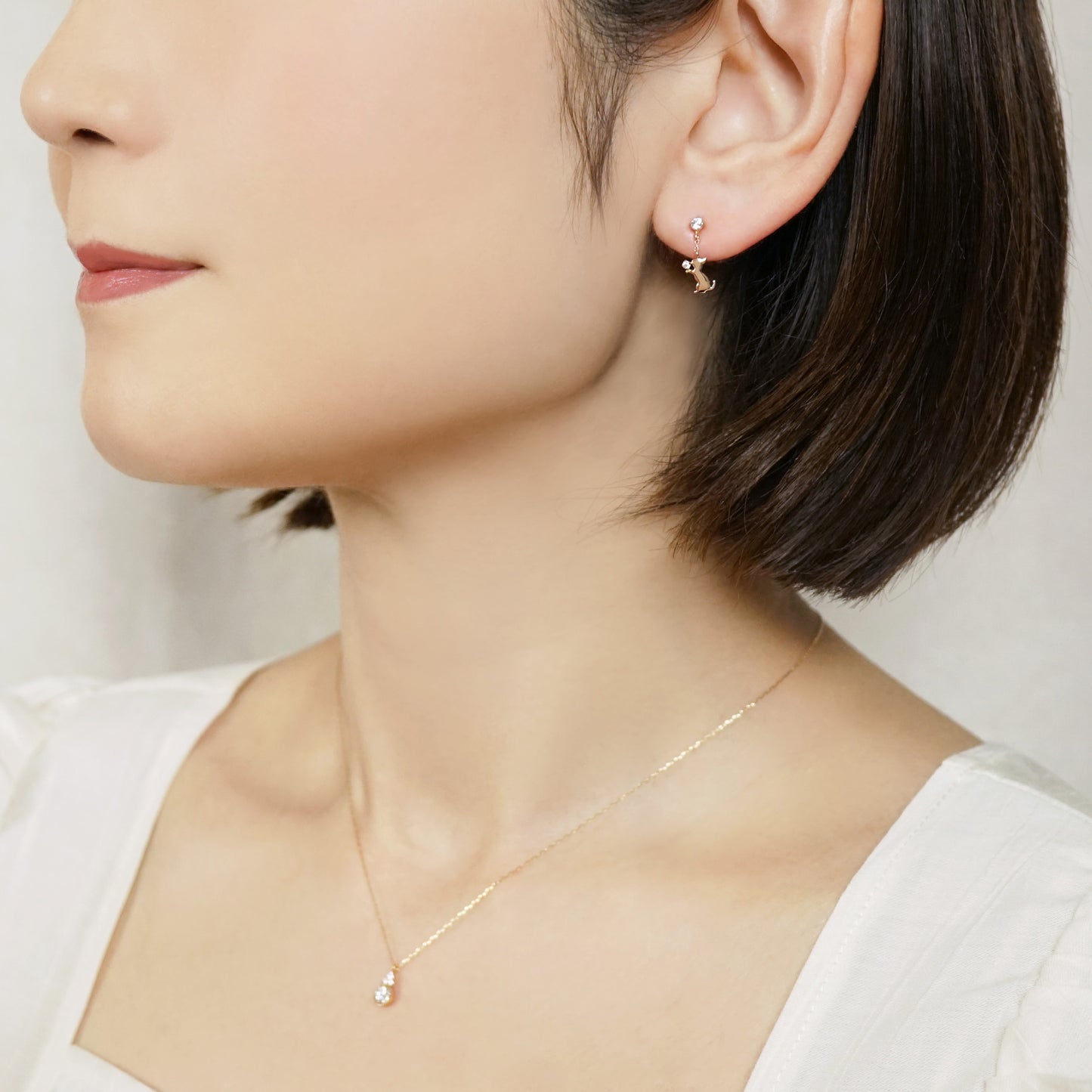 10K Begging Cat Swinging Earrings (Rose Gold) - Model Image