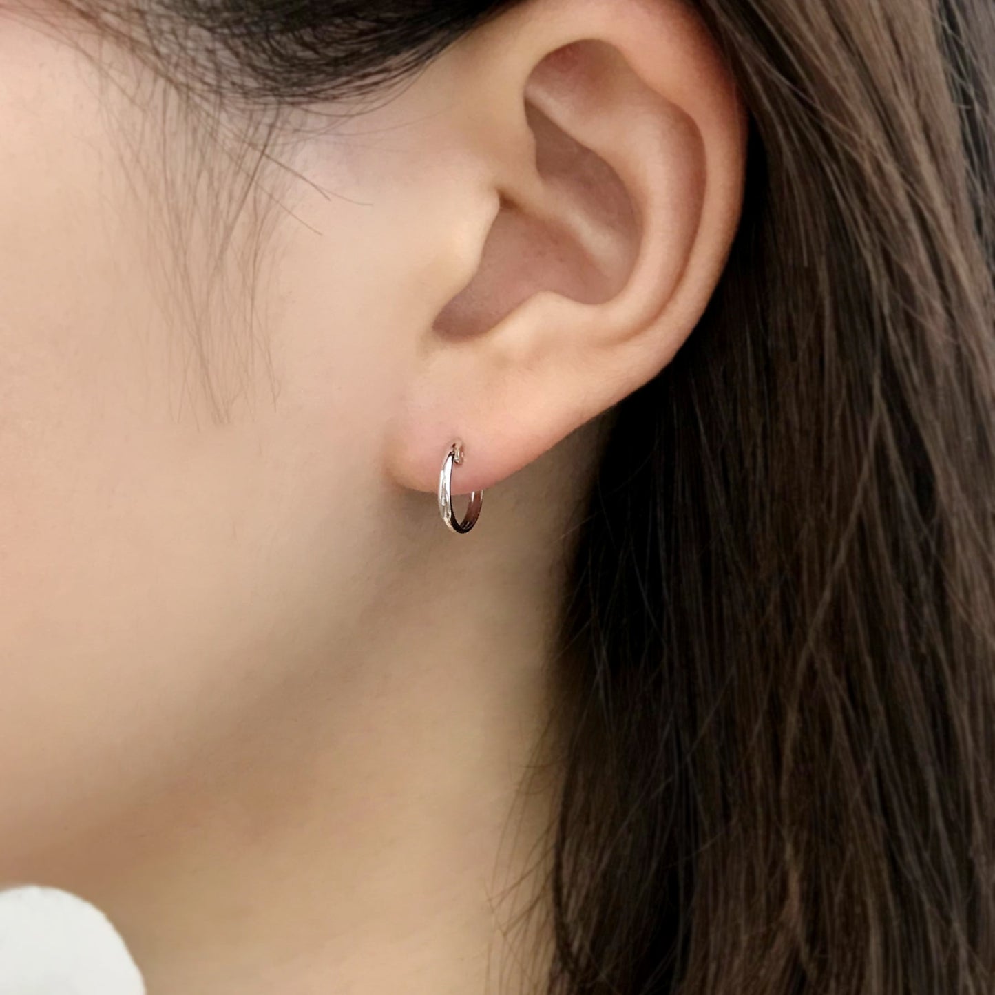 14K/10K White Gold Mini Hoop Earrings - Model Image