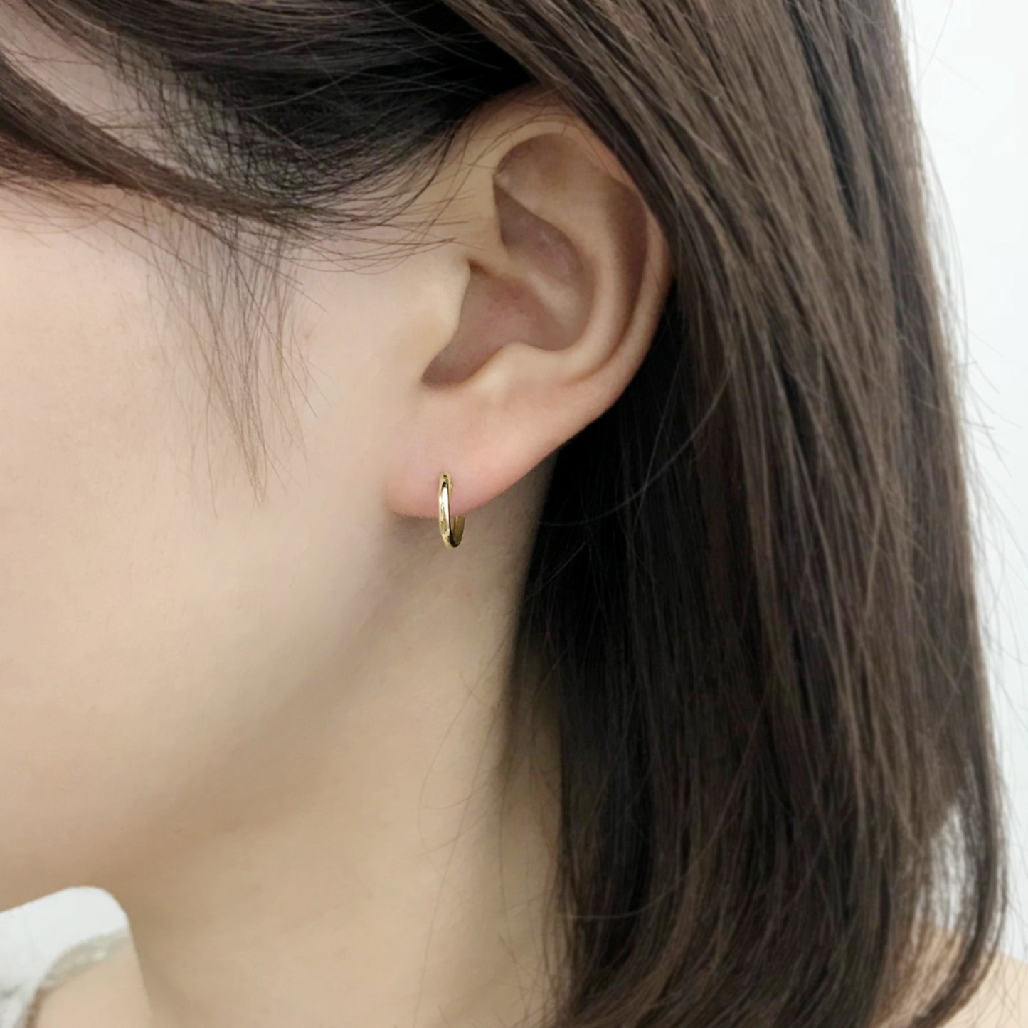 18K/10K Yellow Gold Mini Hoop Earrings - Model Image
