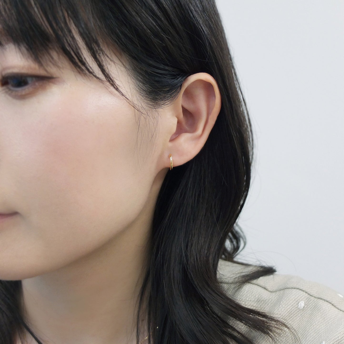 18K/10K Yellow Gold Mini Hoop Earrings - Model Image