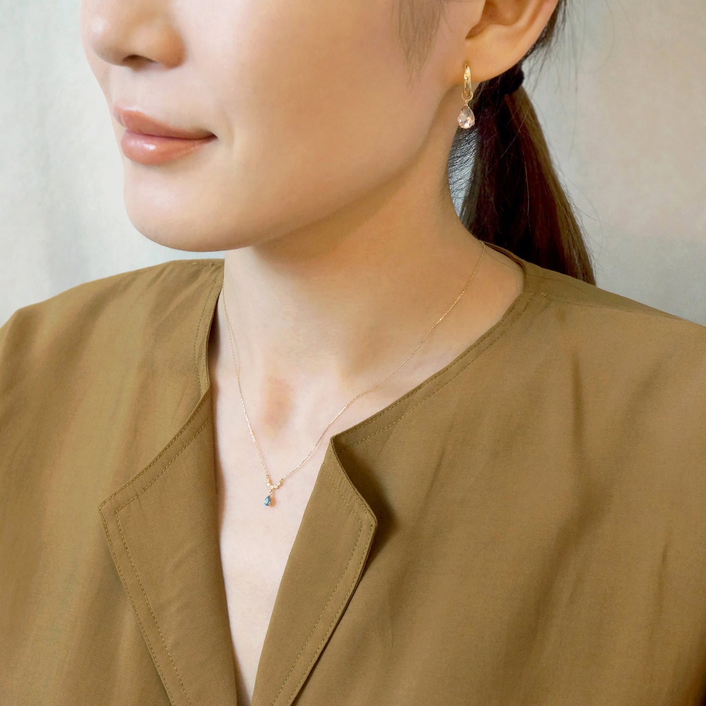 10K Yellow Gold Birthstone (Swiss Blue Topaz) Swinging Necklace - Model Image