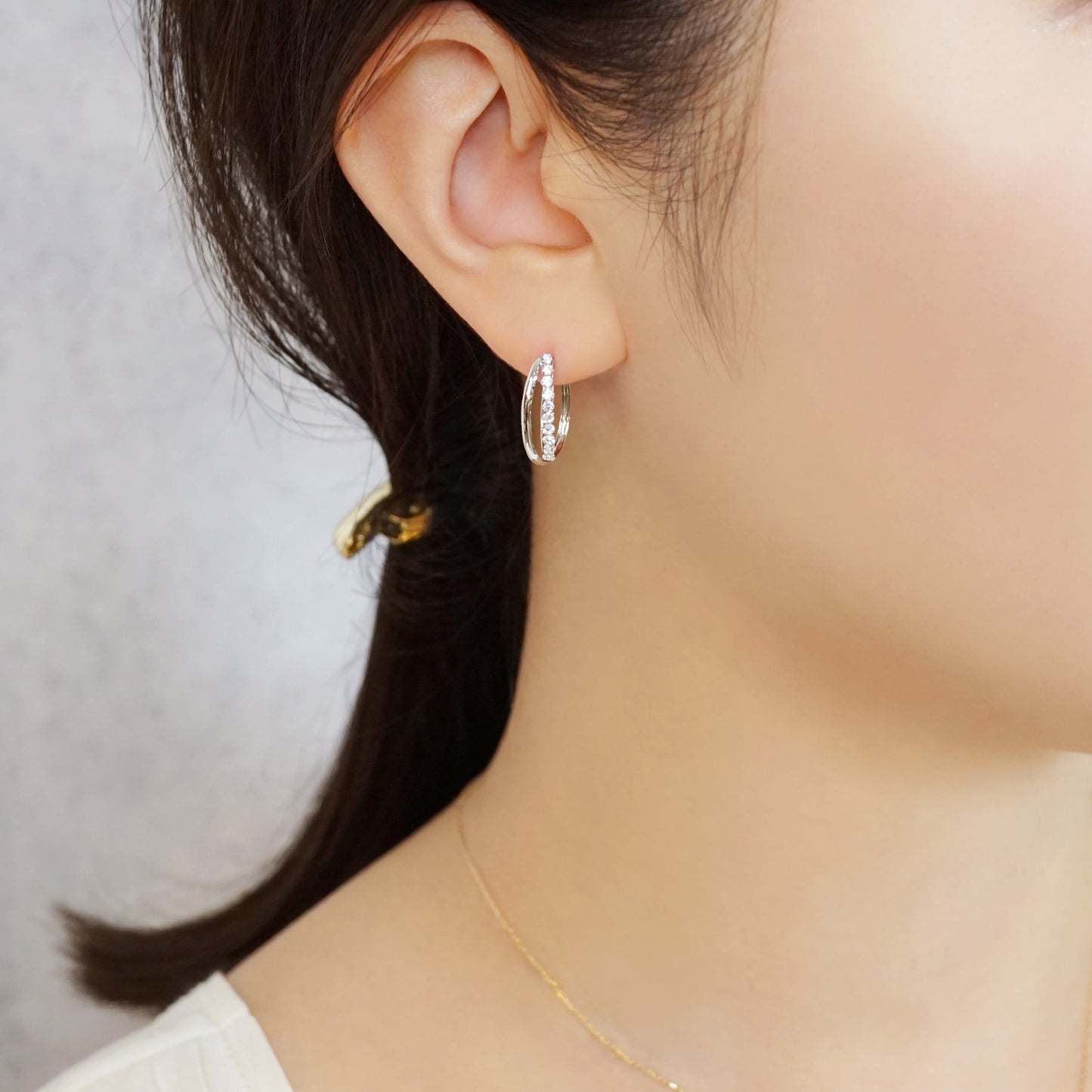 14K/10K Cubic Zirconia Oval Hoop Earrings (White Gold) - Model Image