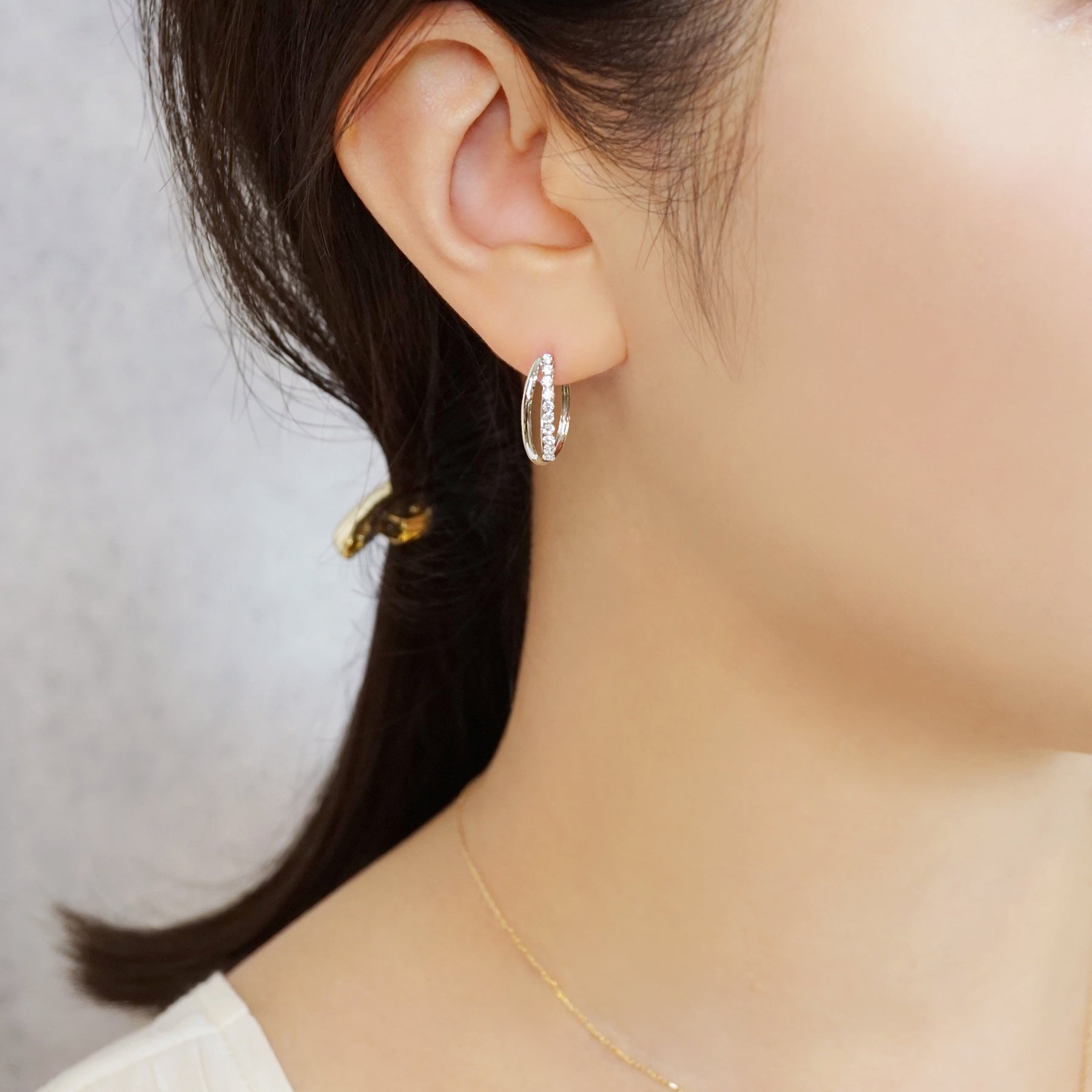 14K/10K Cubic Zirconia Oval Hoop Earrings (White Gold) - Model Image