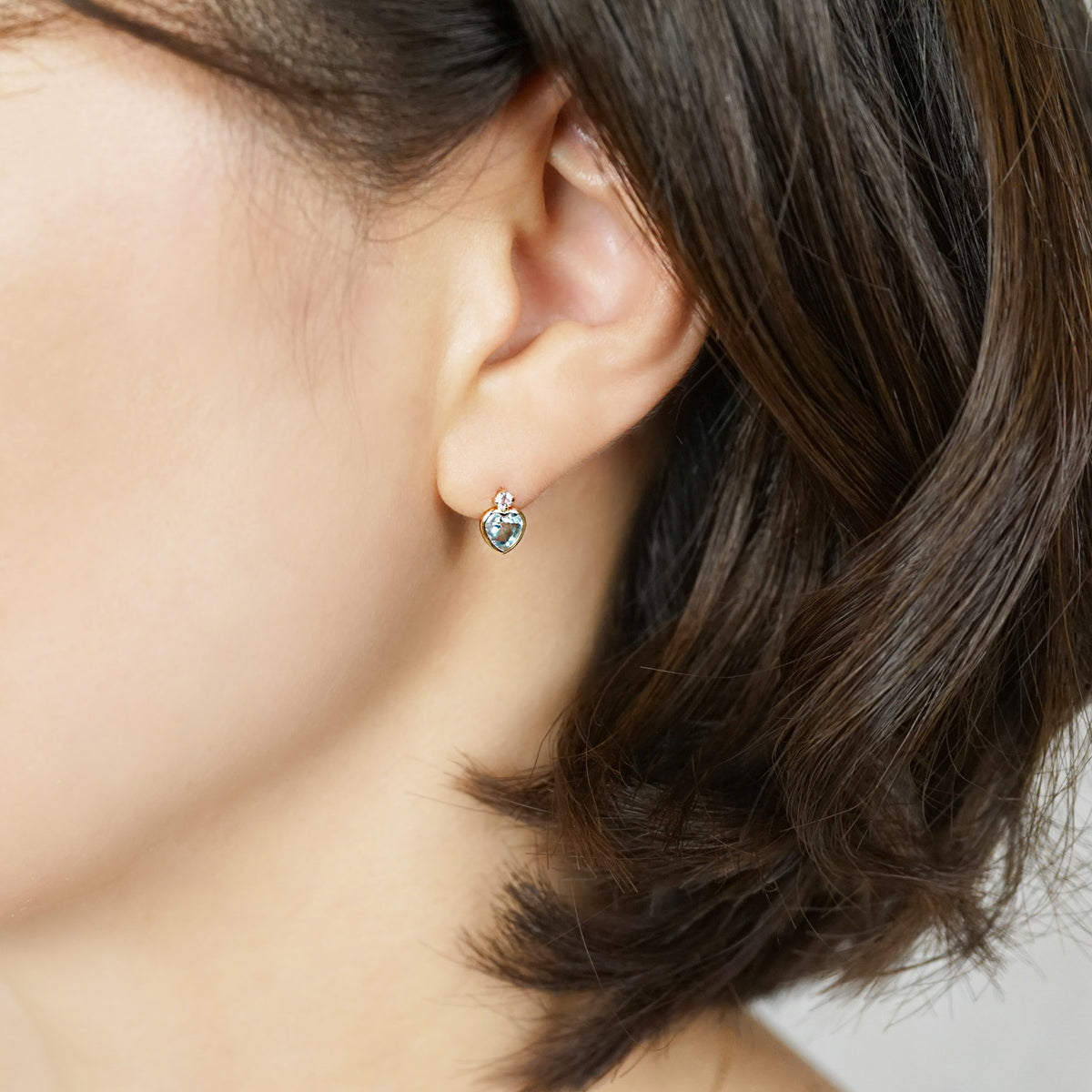 10K Sky Blue Topaz Heart Love Earrings (Yellow Gold) - Model Image