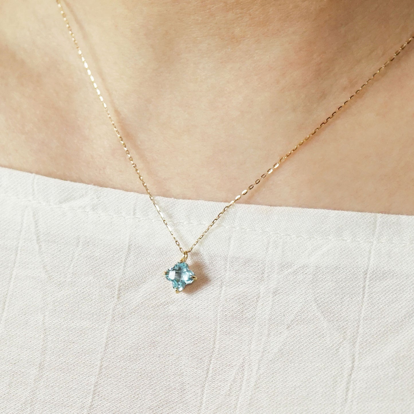 10K Blue Topaz Lily Necklace (Yellow Gold) - Model Image