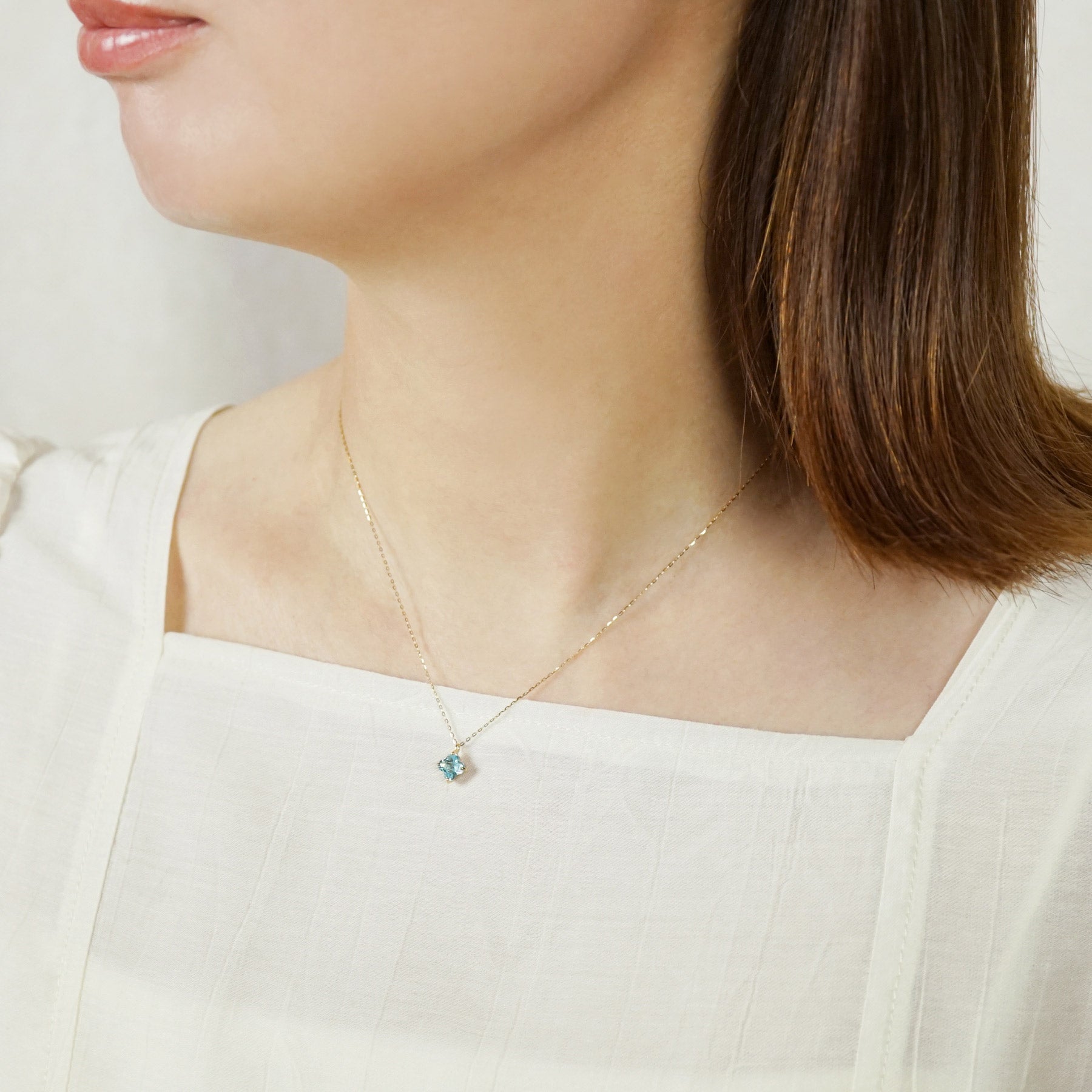 10K Blue Topaz Lily Necklace (Yellow Gold) - Model Image