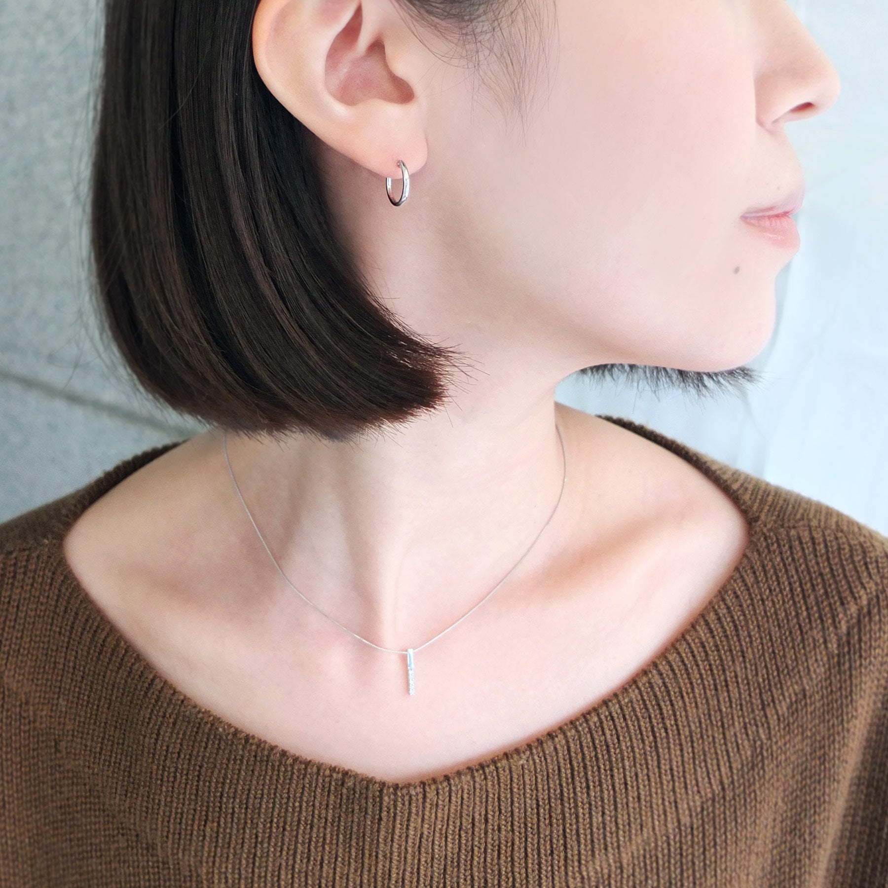 Platinum Pipe Hoop Earrings - Model Image