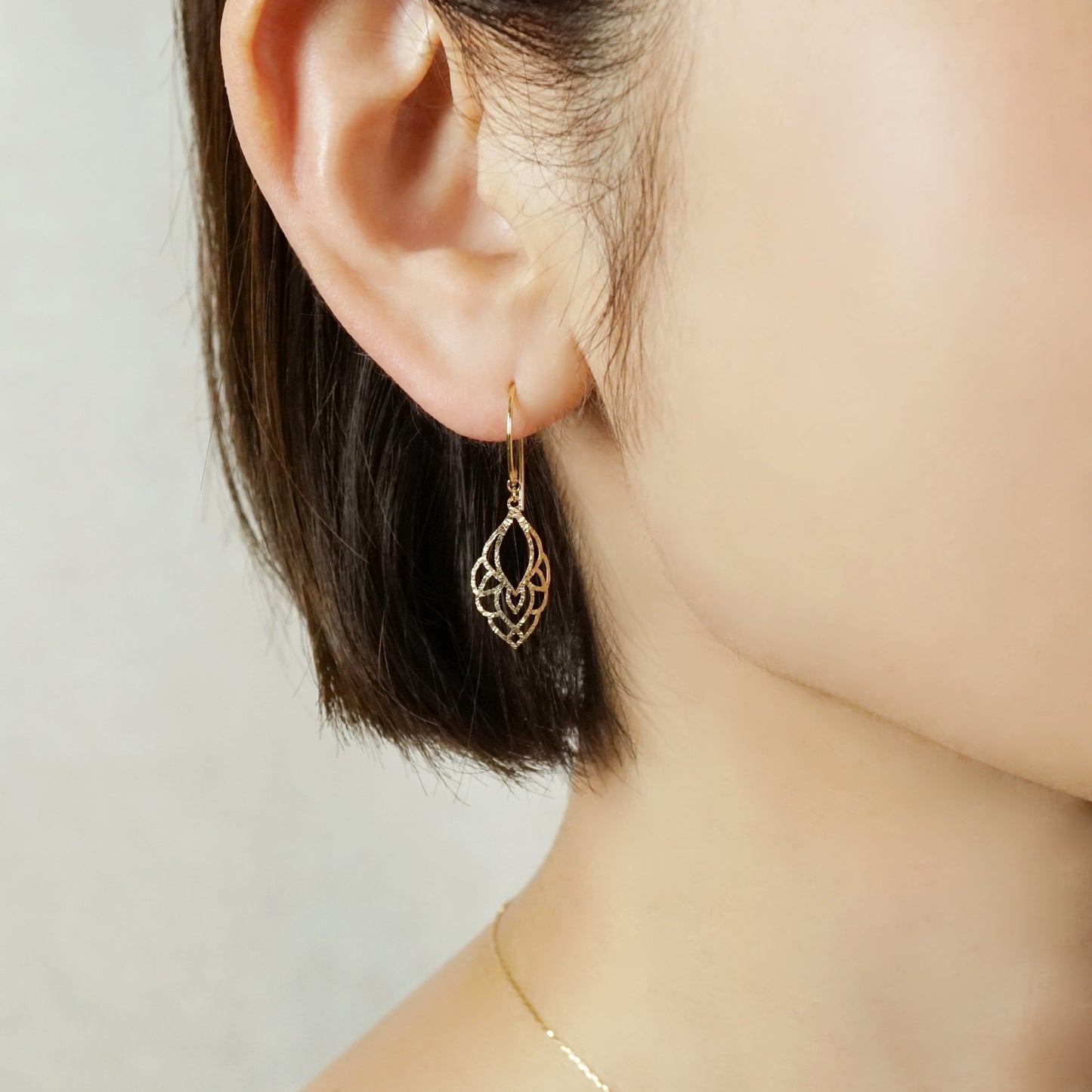 10K Openwork Leaf Earrings (Yellow Gold) - Model Image
