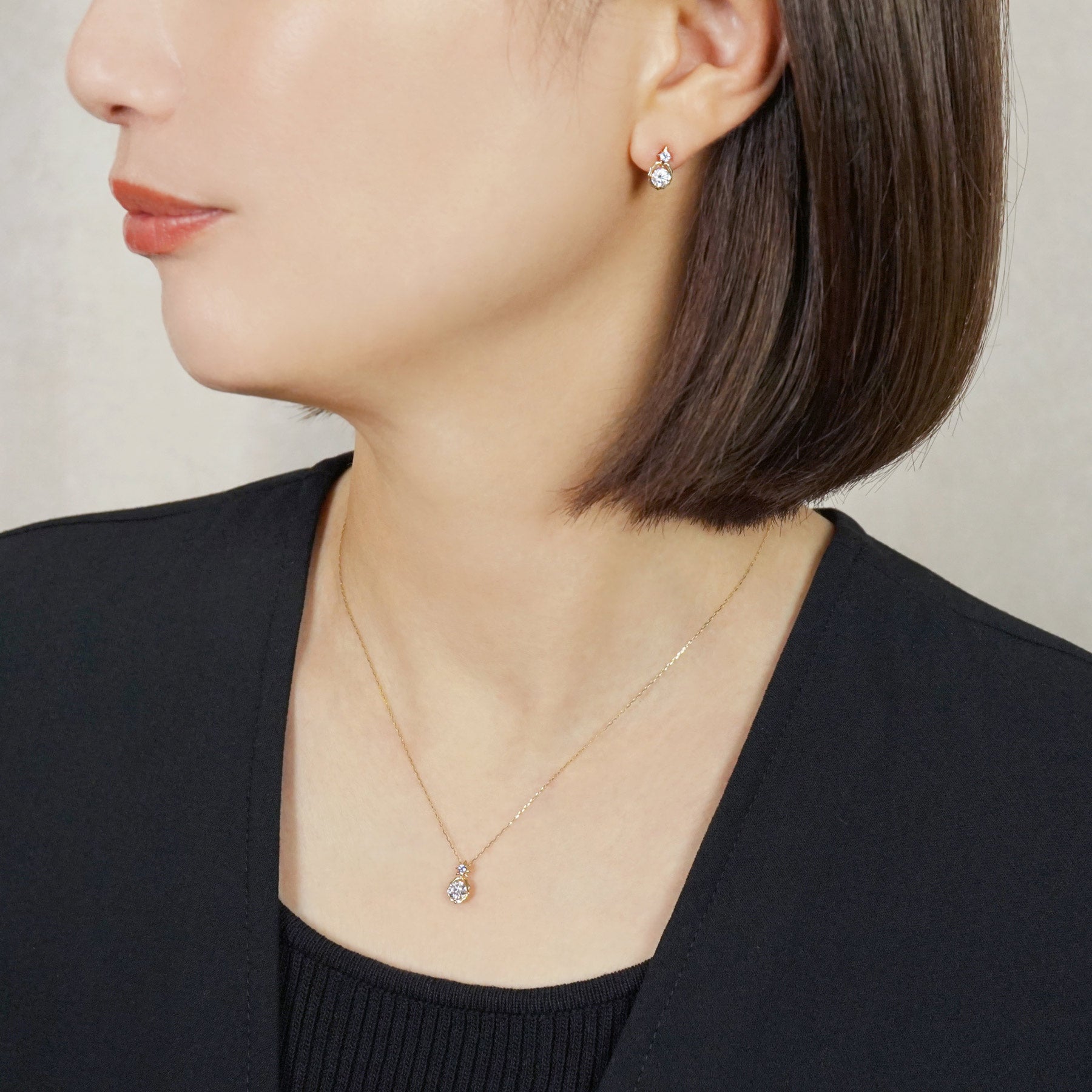 10K Sirius Moissanite Earrings (Yellow Gold) - Model Image