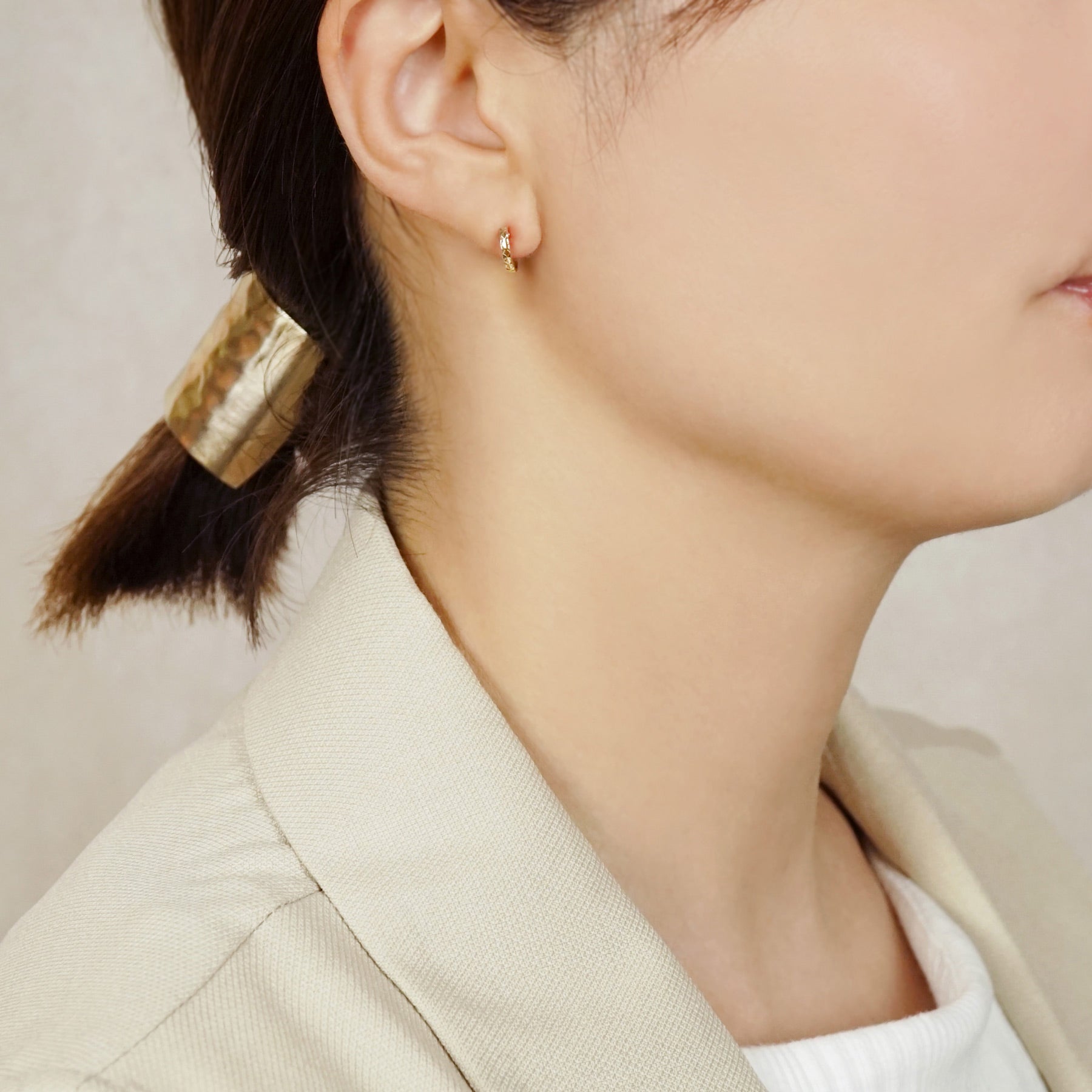 10K Faceted Mini Hoop Earrings (Yellow Gold) - Model Image
