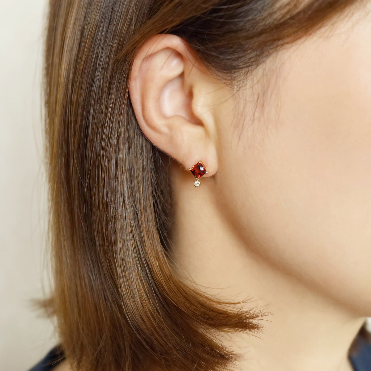 10K Garnet Checkerboard Cut Stud Earrings (Yellow Gold) - Model Image