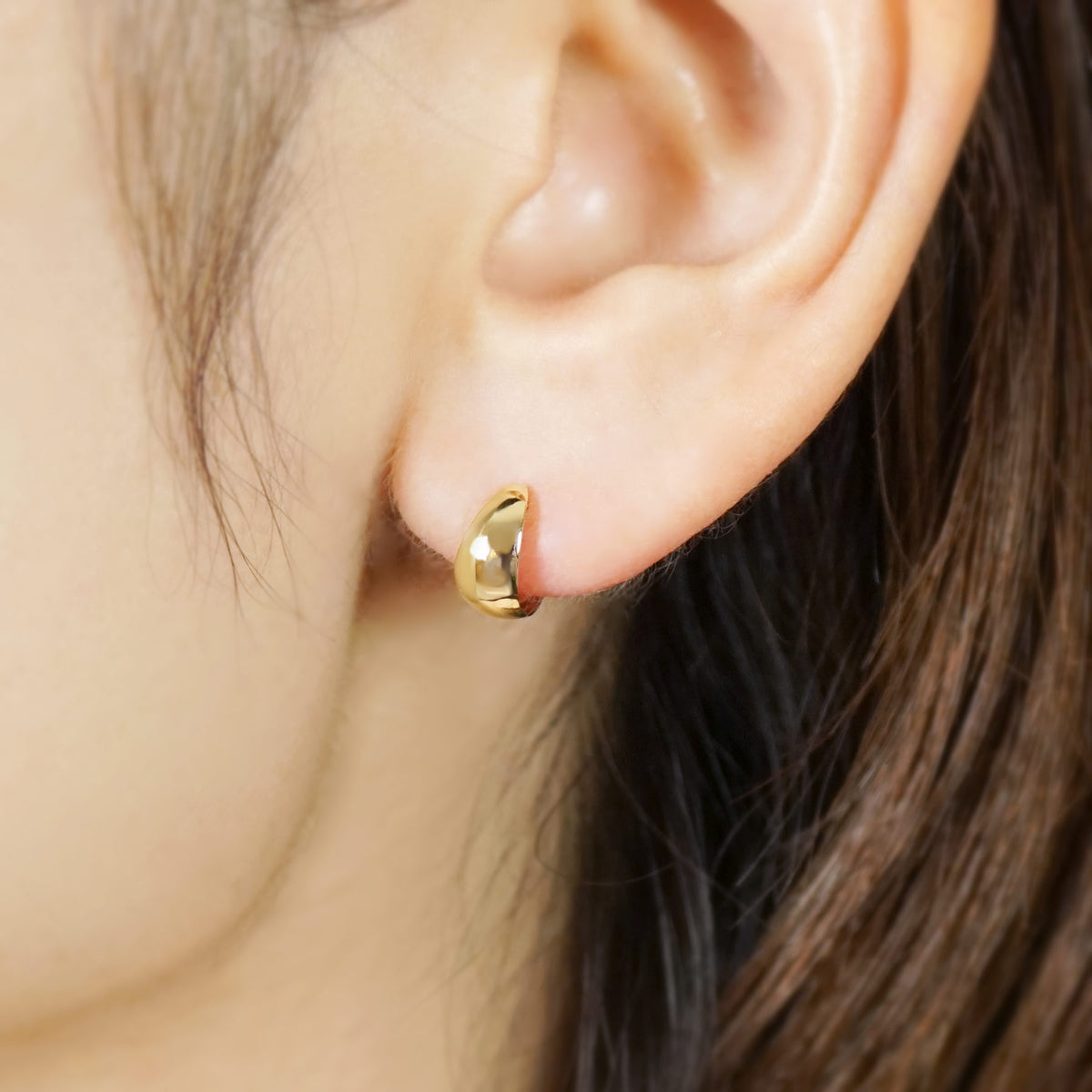 10K Plump Mini Hoop Earrings (Yellow Gold) - Model Image