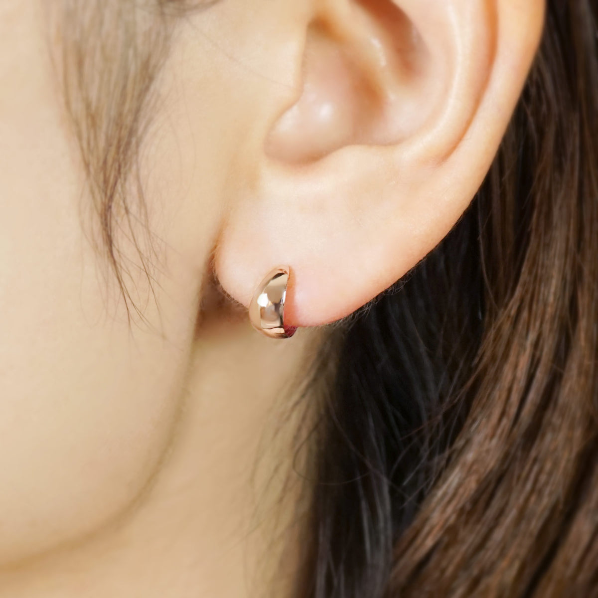 10K Plump Mini Hoop Earrings (Rose Gold) - Model Image