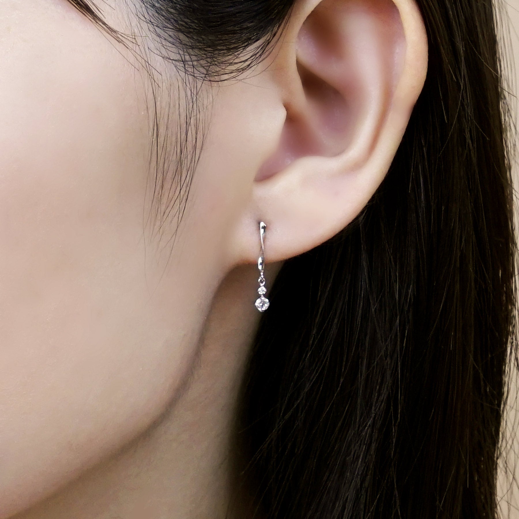 14K / 10K White Gold Diamond Twisted Earrings - Model Image