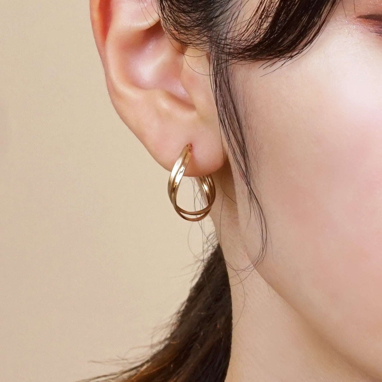 18K/10K Yellow Gold Twisted Twin Hoop Earrings (Large) - Model Image
