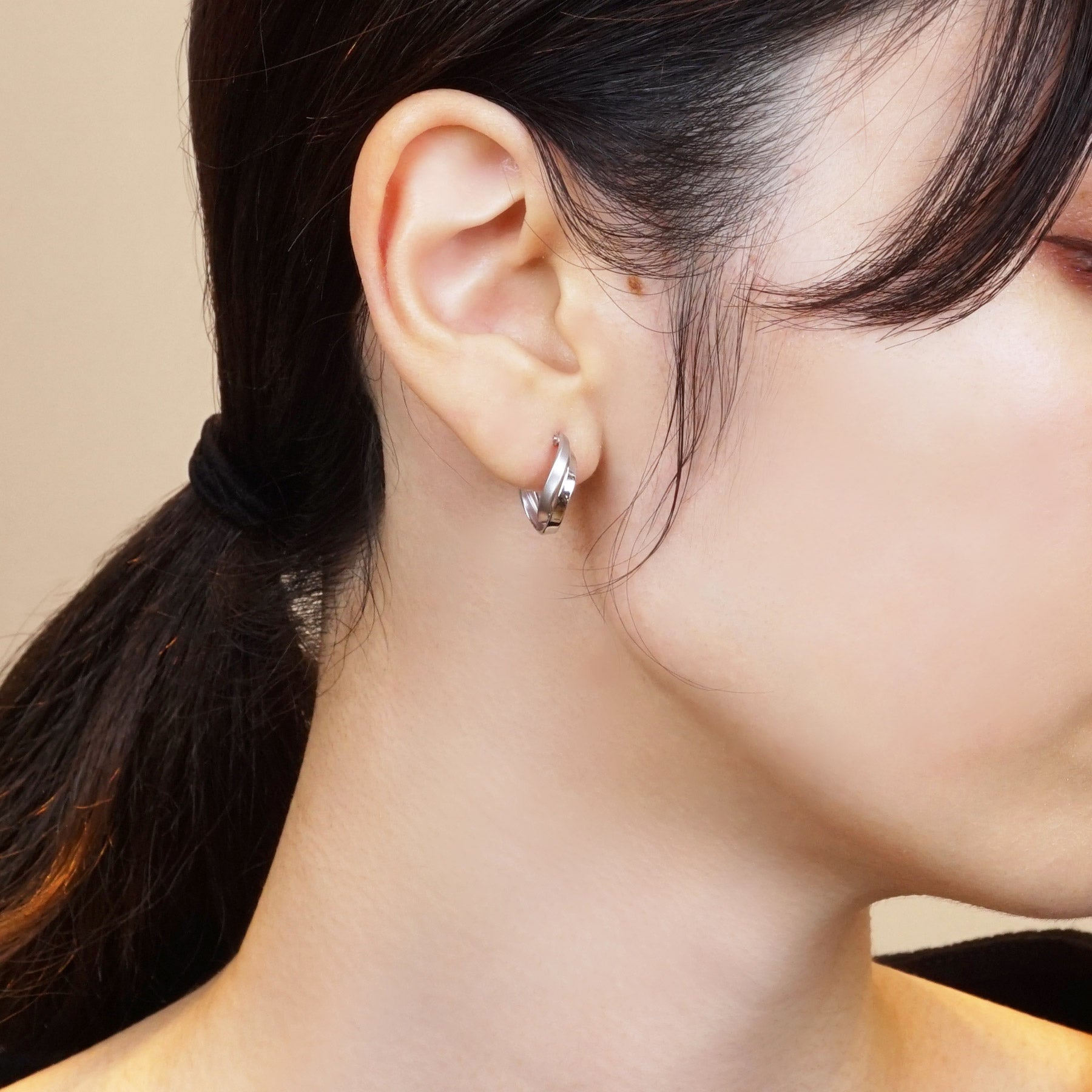 14K/10K White Gold Twisted Twin Hoop Earrings - Model Image