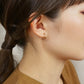 18K/10K Yellow Gold Cut Pipe Hoop Earrings - Model Image