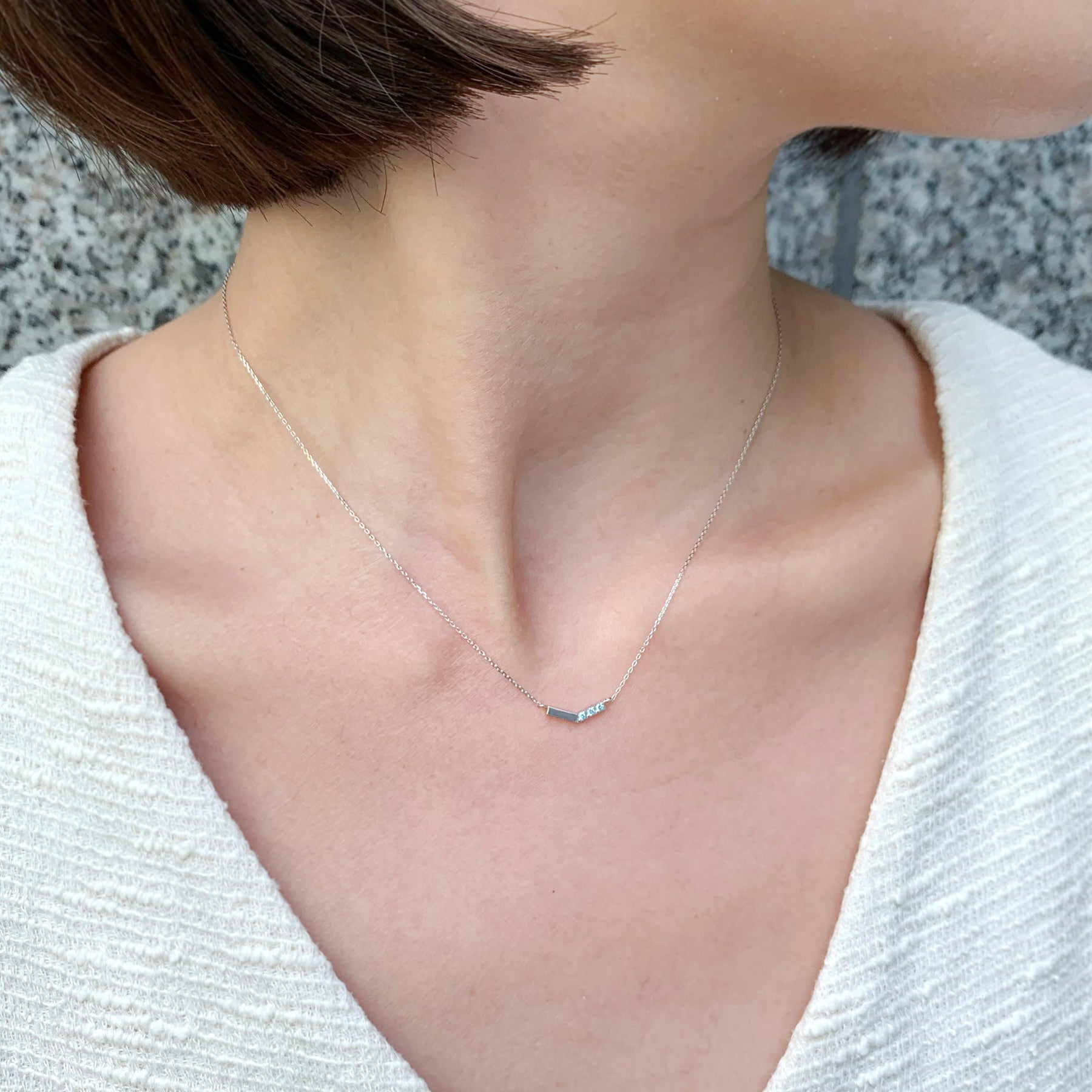10K White Gold Ice Blue Diamond V-Shaped 3-Stone Necklace - Model Image