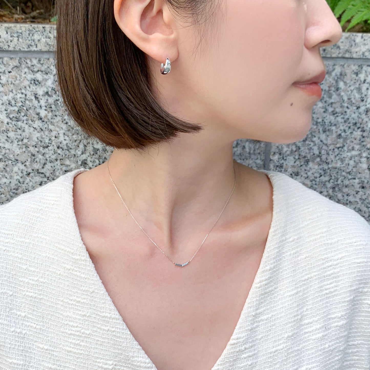 10K White Gold Ice Blue Diamond V-Shaped 3-Stone Necklace - Model Image