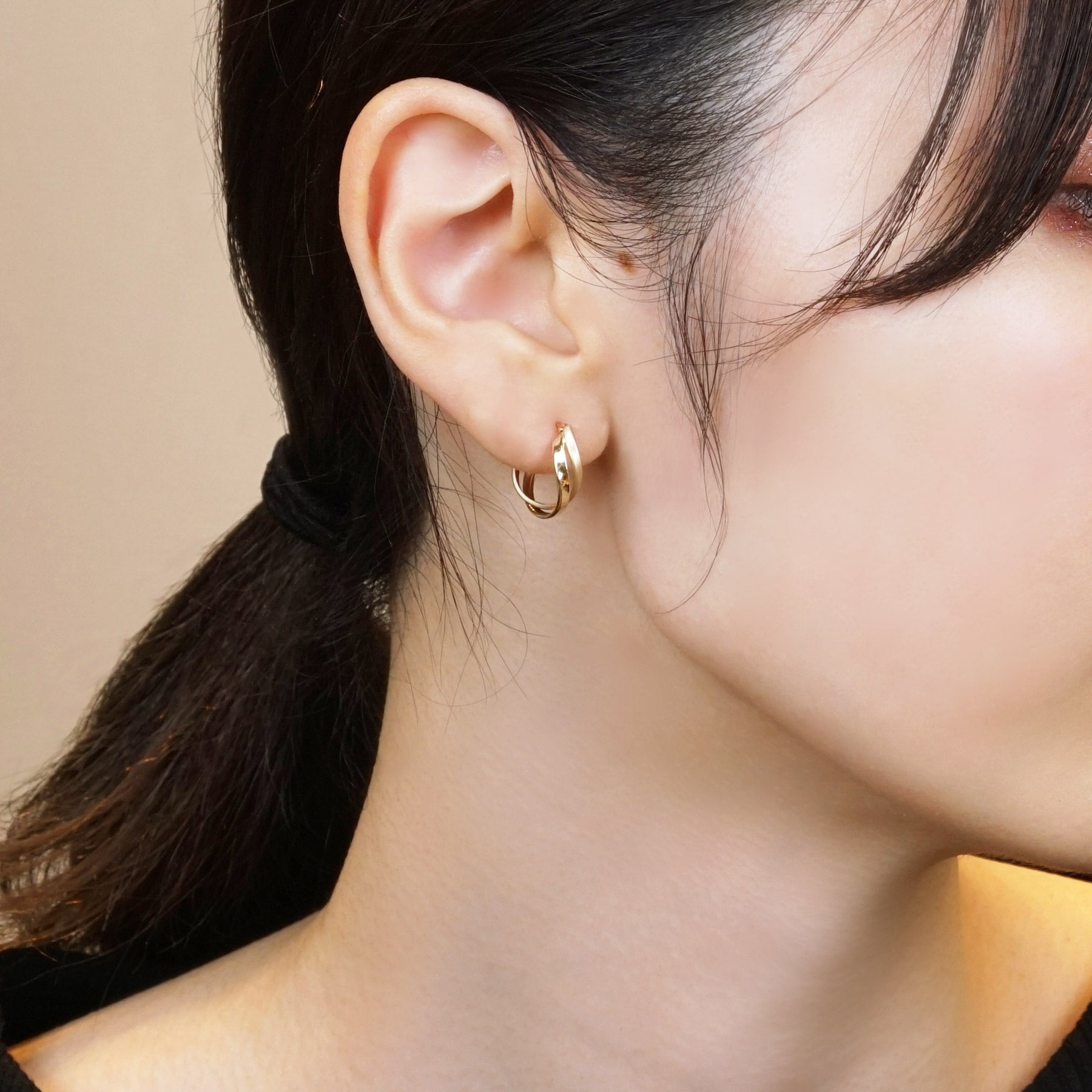 18K/10K Yellow Gold Twisted Twin Hoop Earrings - Model Image