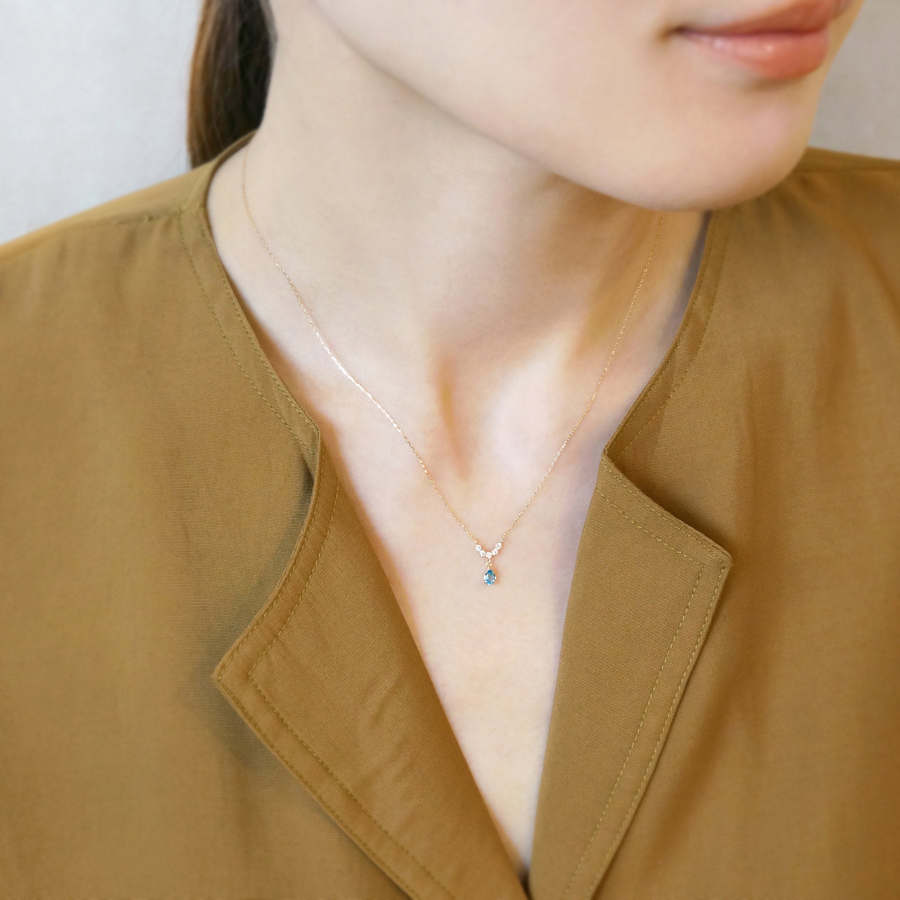 10K Yellow Gold Birthstone (Swiss Blue Topaz) Swinging Necklace - Model Image